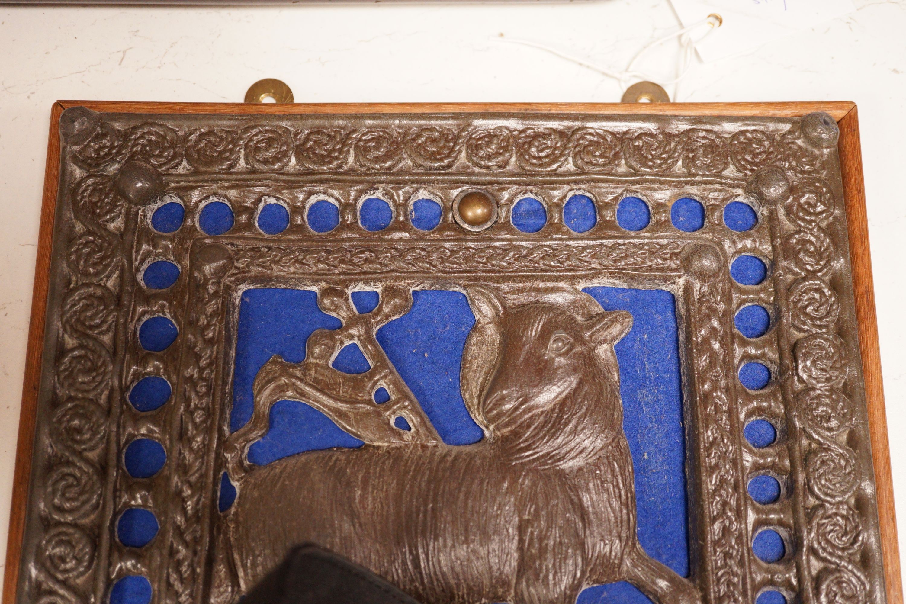 A wall mounted Lamb of God cast metal panel, 31 x 29cm
